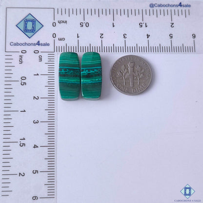 cabochons4sale, emerald green malachite rectangle gemstone cabochons featuring flowing circular patterns and distinctive natural stone texture held between fingers