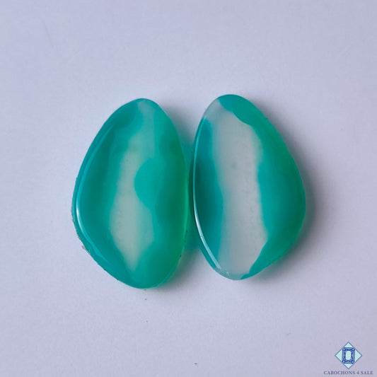 cabochons4sale, fancy green banded agate cabochons with graceful natural striping, layered mineral patterns and rich earthy gemstone tones held between fingers