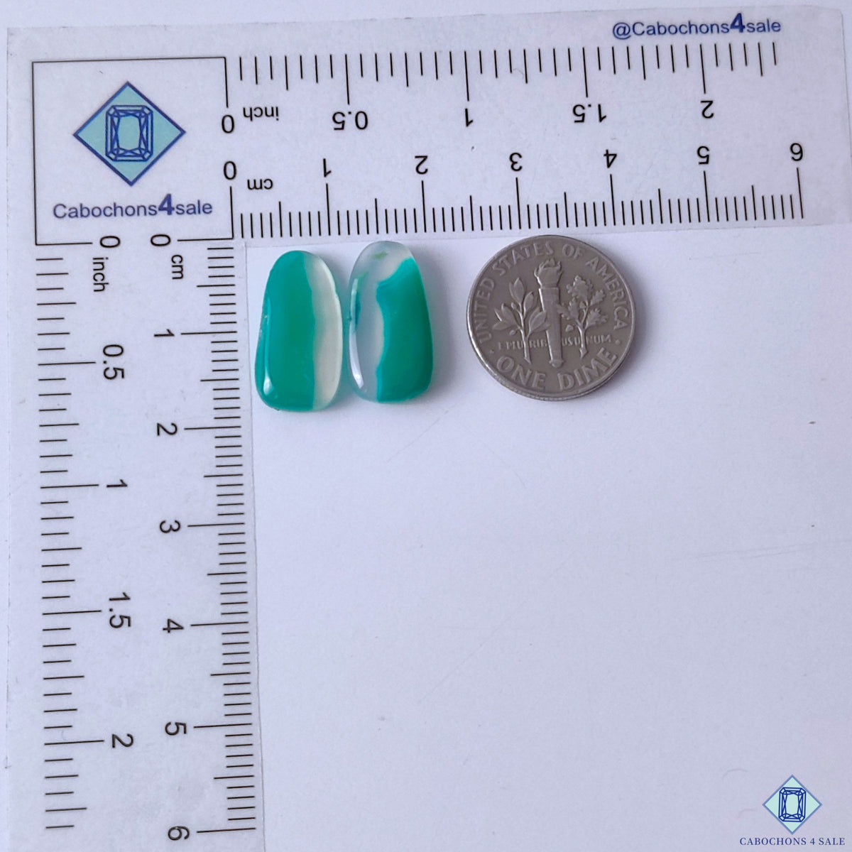 cabochons4sale, fancy green banded agate cabochons in rich green and white shades featuring curved natural banding and distinctive layered gemstone patterns held between fingers