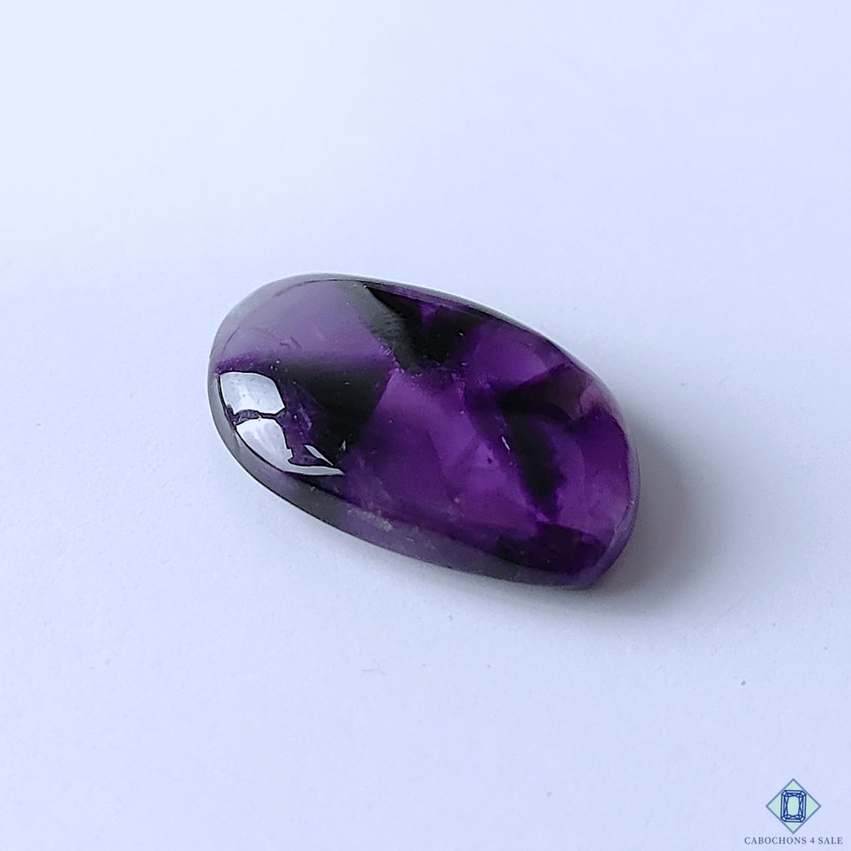 cabochons4sale, polished trapiche amethyst fancy cabochons featuring vivid purple coloration, star-like mineral zoning and distinctive crystalline texture held between fingers