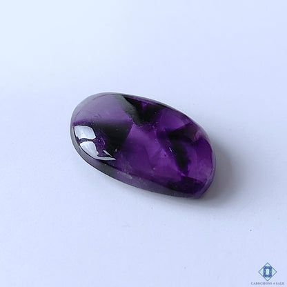cabochons4sale, polished trapiche amethyst fancy cabochons featuring vivid purple coloration, star-like mineral zoning and distinctive crystalline texture held between fingers