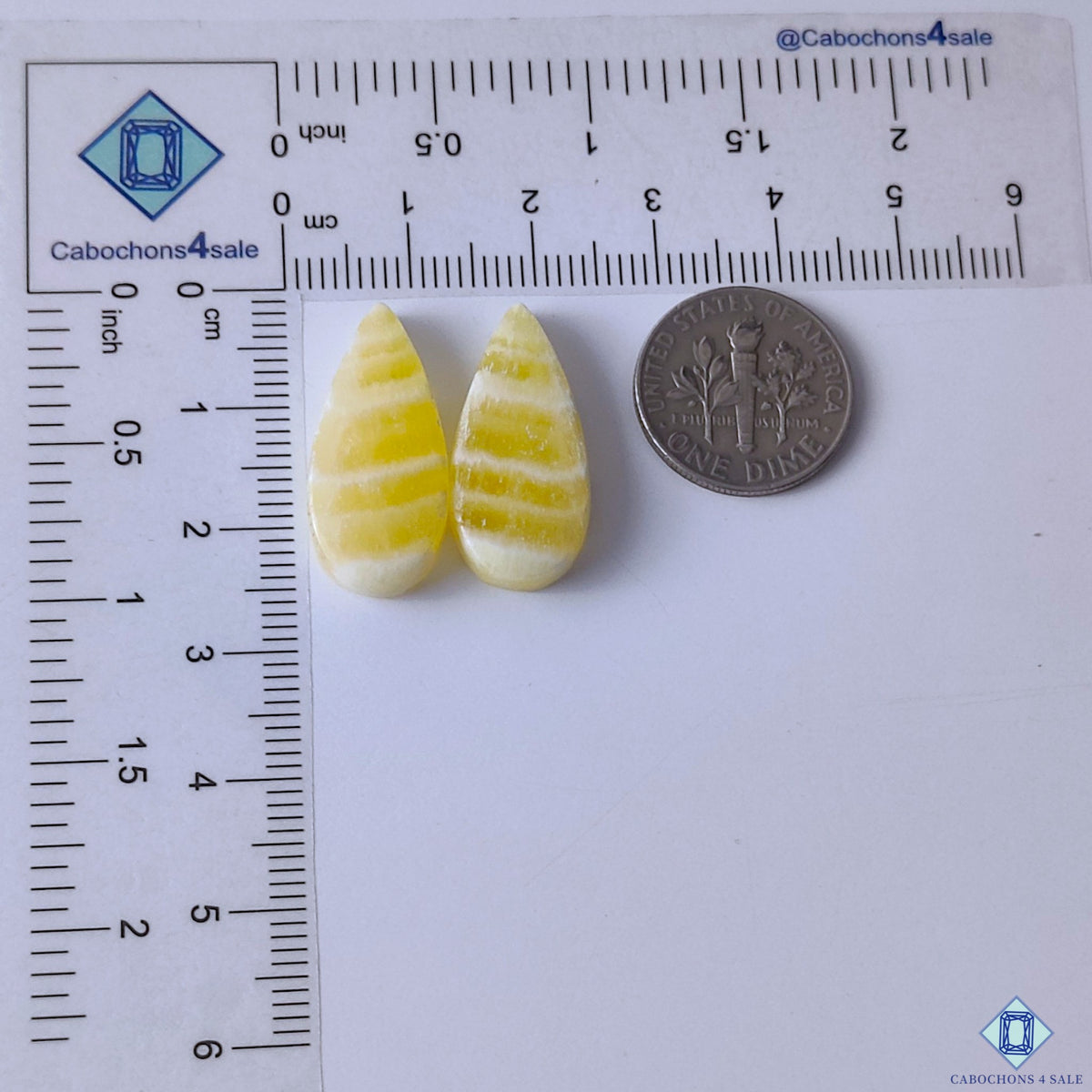 cabochons4sale, golden yellow calcite pear gemstone cabochons featuring gentle color variation, luminous texture and polished stone surfaces held between fingers