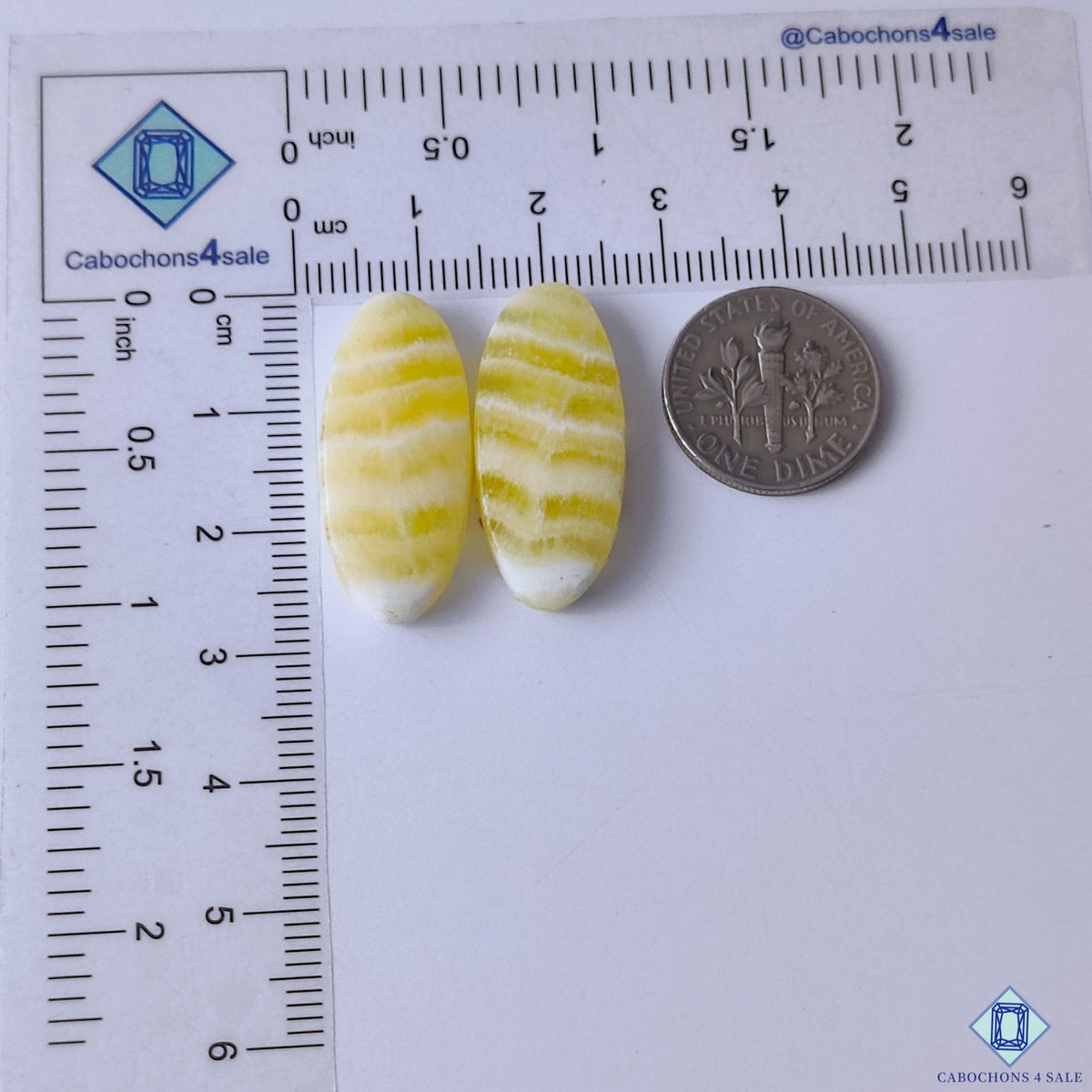 cabochons4sale, golden yellow calcite oval gemstone cabochons featuring soft color variation, luminous mineral texture and elegant stone polish held between fingers