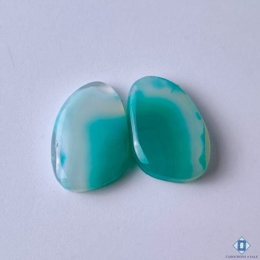 cabochons4sale, fancy green banded agate cabochons in green and white shades with delicate striped formations, natural mineral movement and smooth polished texture held between fingers