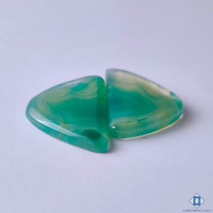 cabochons4sale, polished fancy green banded agate cabochons showcasing distinctive natural striping, organic mineral layers and elegant gemstone character held between fingers