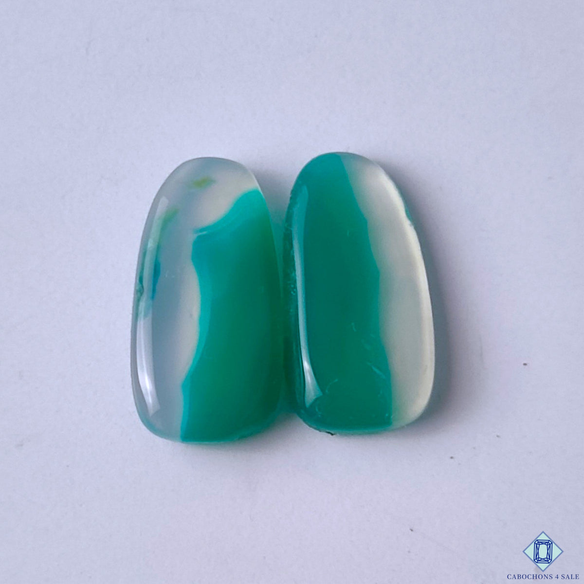 cabochons4sale, green and white green banded agate fancy cabochons with intricate flowing stripes, organic mineral layers and polished surfaces held between fingers