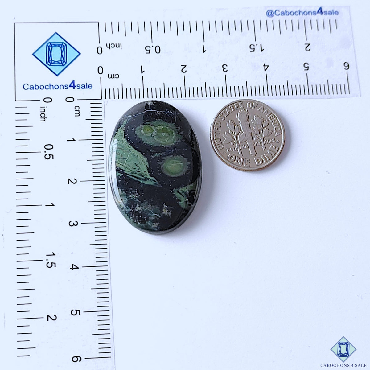 cabochons4sale, green and black Kambaba Jasper oval cabochons featuring swirling circular markings, earthy mineral details and smooth polished texture held between fingers