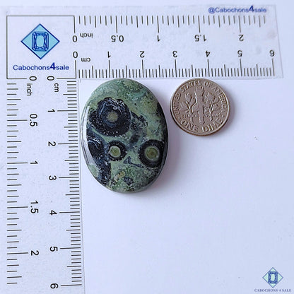 cabochons4sale, green Kambaba Jasper oval cabochons accented by dark black swirls, organic circular formations and distinctive polished gemstone character held between fingers