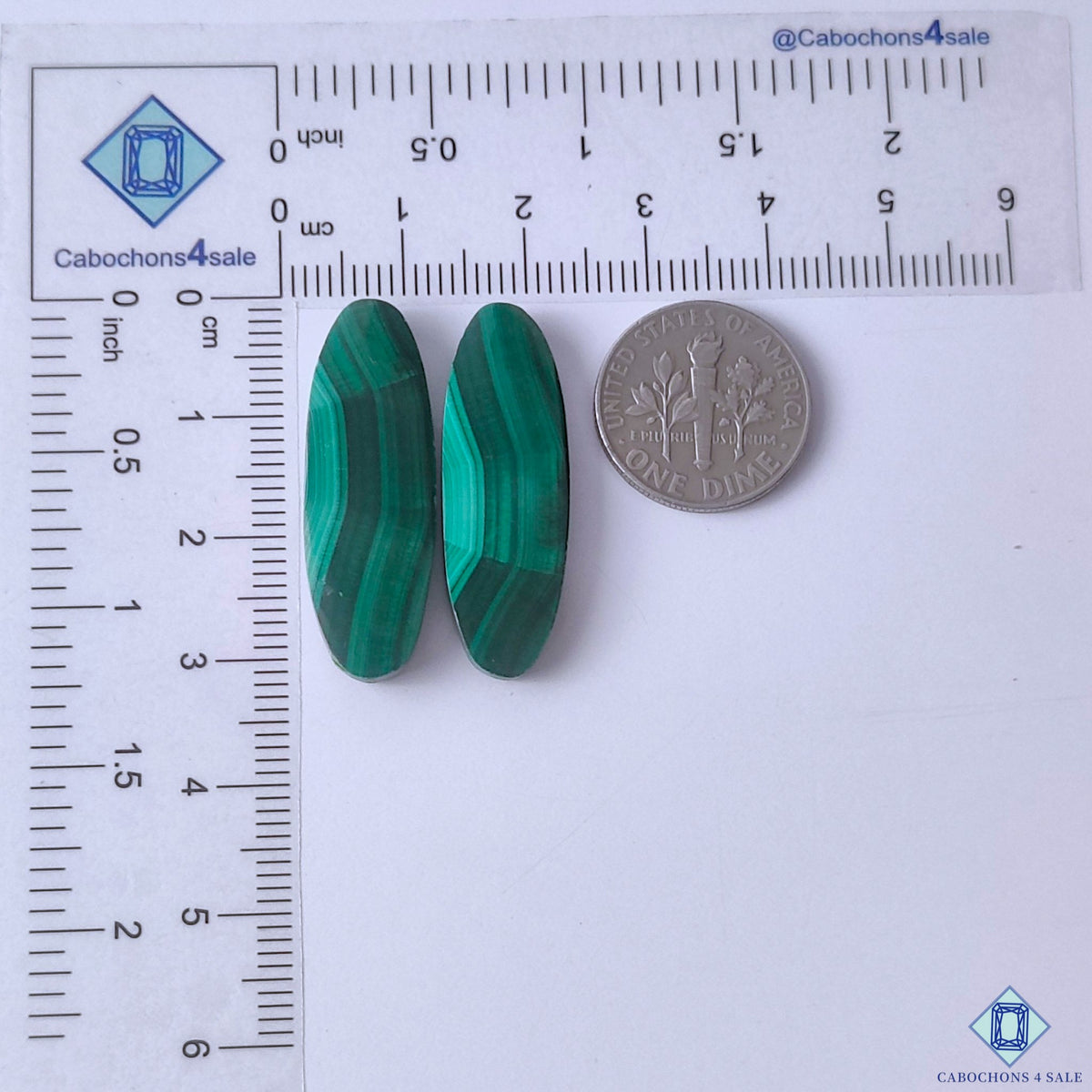cabochons4sale, polished green malachite oval gemstone cabochons displaying vivid color layers, organic banded patterns and smooth stone surfaces held between fingers