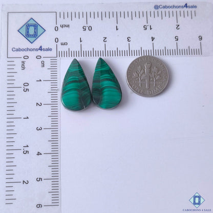 cabochons4sale, vibrant green malachite pear gemstone cabochons featuring elegant swirling mineral bands and distinctive natural stone character held between fingers