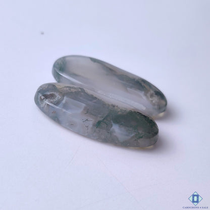 cabochons4sale, artisan-polished oval moss agate cabochons in vibrant green hues with unique mossy inclusions and captivating gemstone texture held between fingers