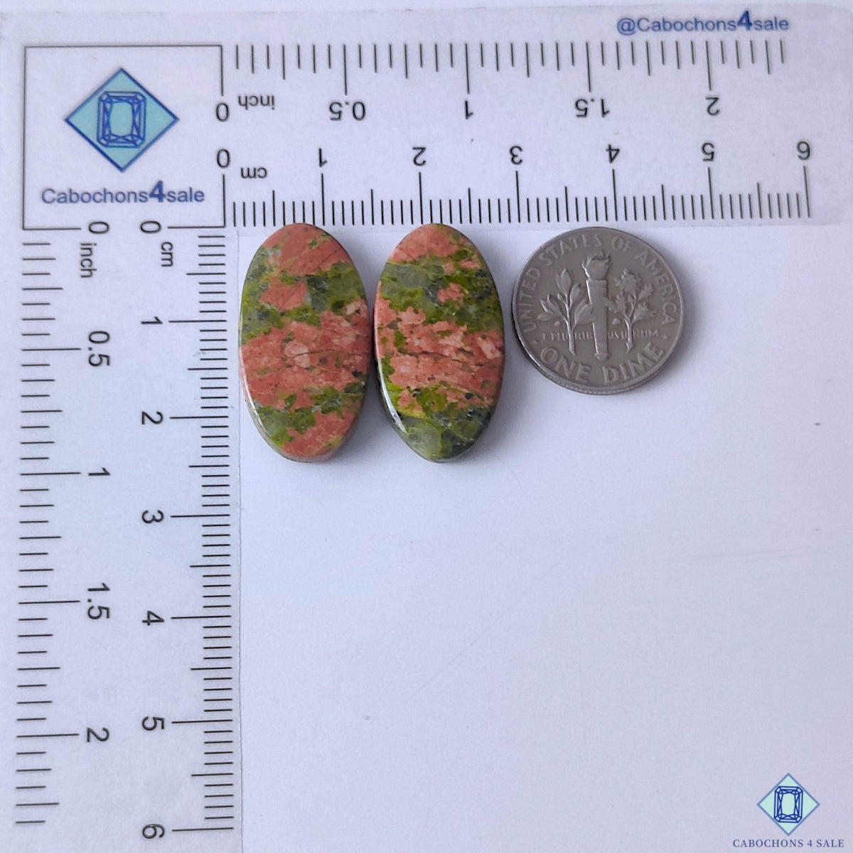 cabochons4sale, green and peach-orange unakite oval gemstone cabochons featuring distinctive feldspar and epidote color patterns with a smooth finish held between fingers