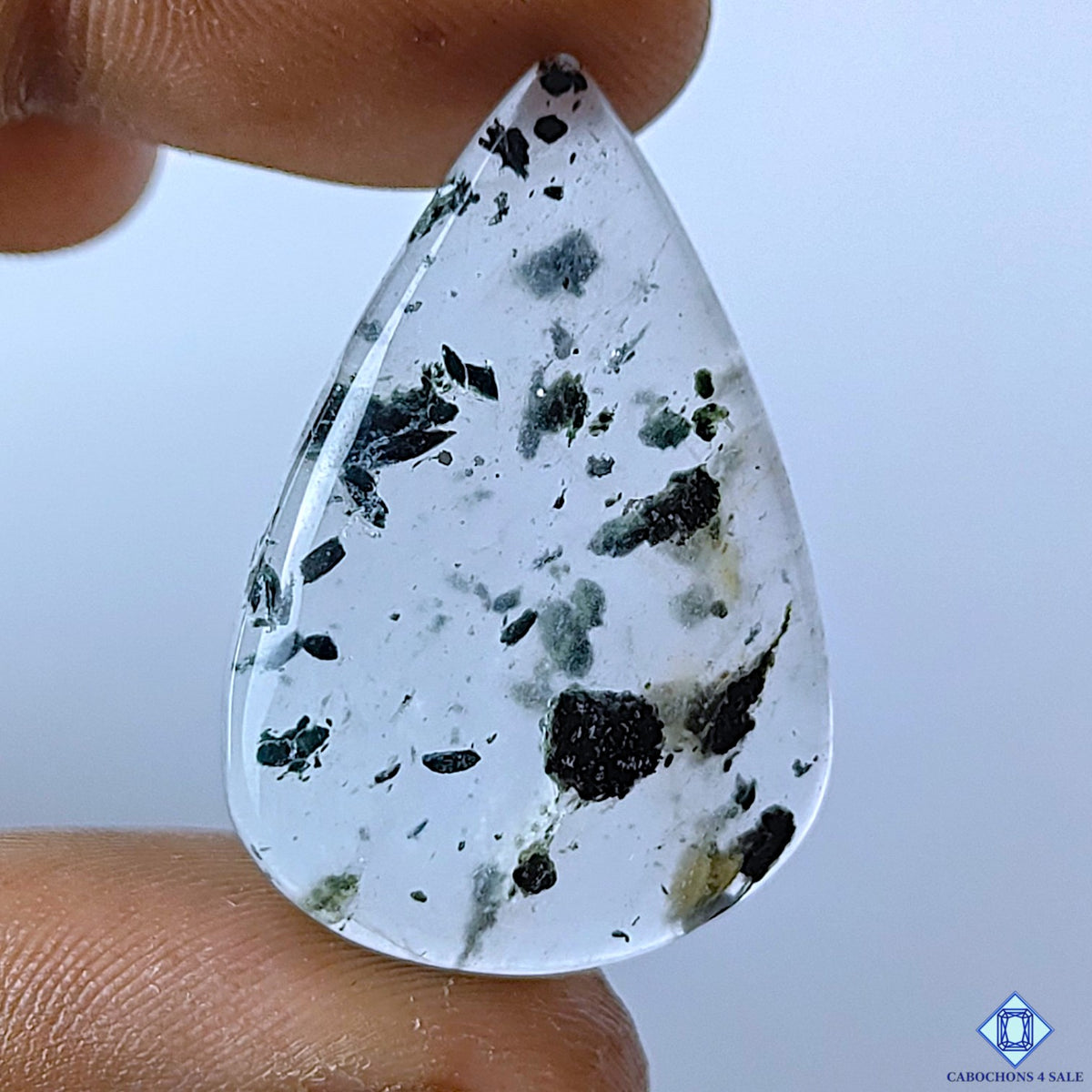 cabochons4sale, green tourmaline quartz pear cabochons with contrasting green tourmaline inclusions in a white quartz matrix, natural patterns and polished surfaces held between fingers