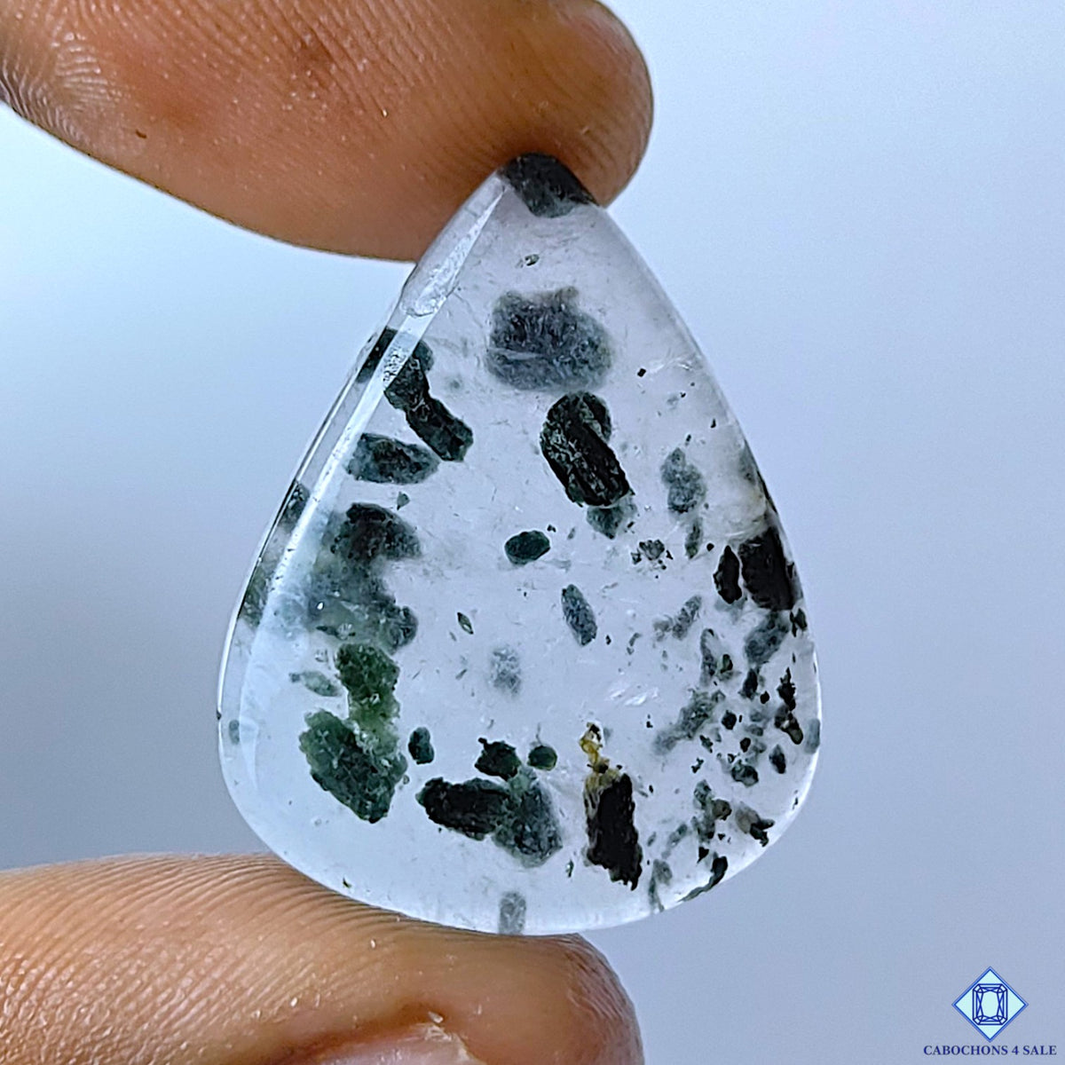 cabochons4sale, green tourmaline quartz pear cabochons featuring vivid green inclusions within a creamy white quartz matrix and natural mineral patterns held between fingers