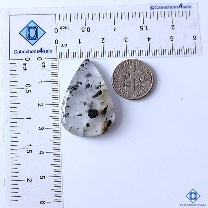 cabochons4sale, natural green tourmaline quartz pear cabochons featuring needle-like green inclusions across a bright white quartz base with distinctive mineral texture held between fingers