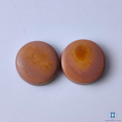 cabochons4sale, natural brown imperial gemstone round cabochons with earthy tones, subtle mineral patterns and smooth polished surfaces held between fingers