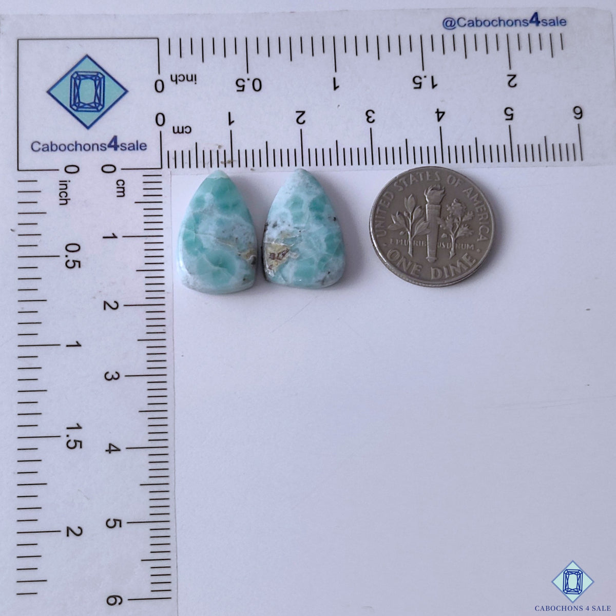cabochons4sale, aqua blue larimar pear gemstone cabochons with contrasting white mineral clouds, organic patterns and glossy stone surfaces held between fingers