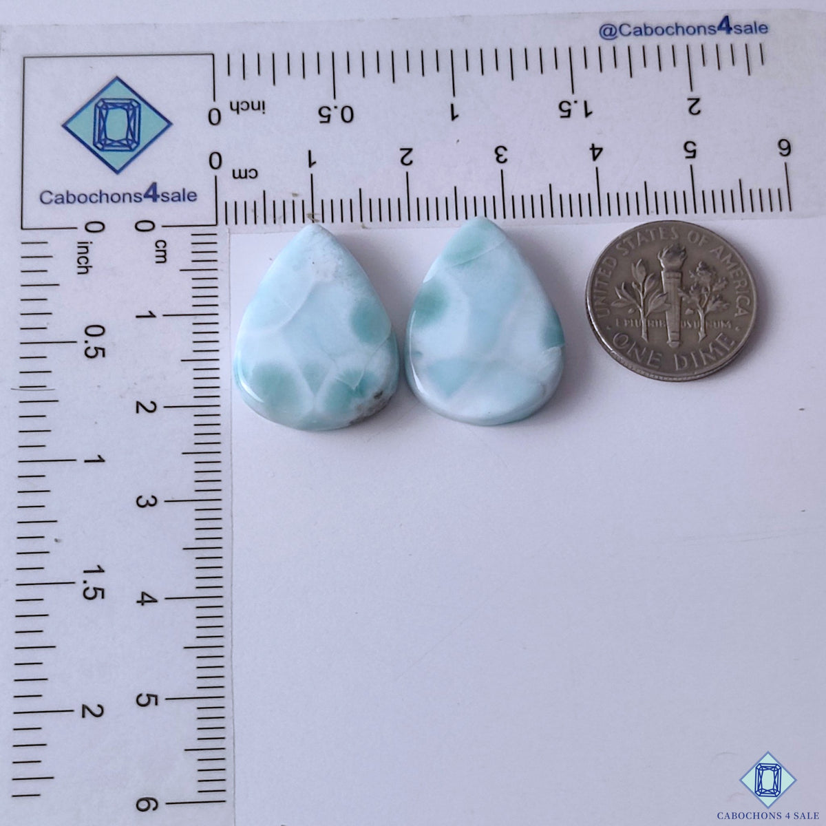 cabochons4sale, blue white larimar pear gemstone cabochons showcasing beautiful marbled mineral patterns, oceanic color tones and smooth polished surfaces held between fingers