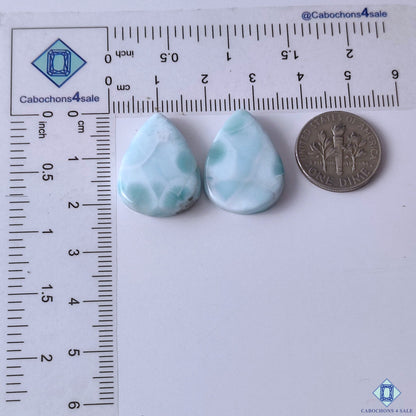 cabochons4sale, blue white larimar pear gemstone cabochons showcasing beautiful marbled mineral patterns, oceanic color tones and smooth polished surfaces held between fingers