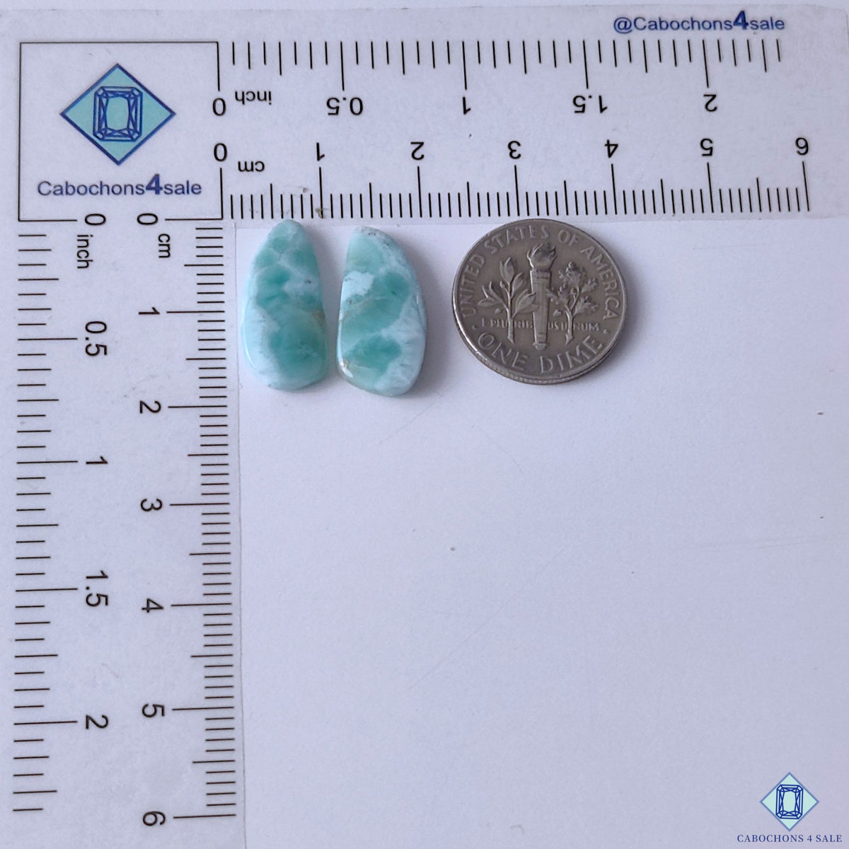 cabochons4sale, aqua blue and white larimar fancy gemstone cabochons displaying soft cloud-like formations, organic mineral patterns and smooth polish held between fingers