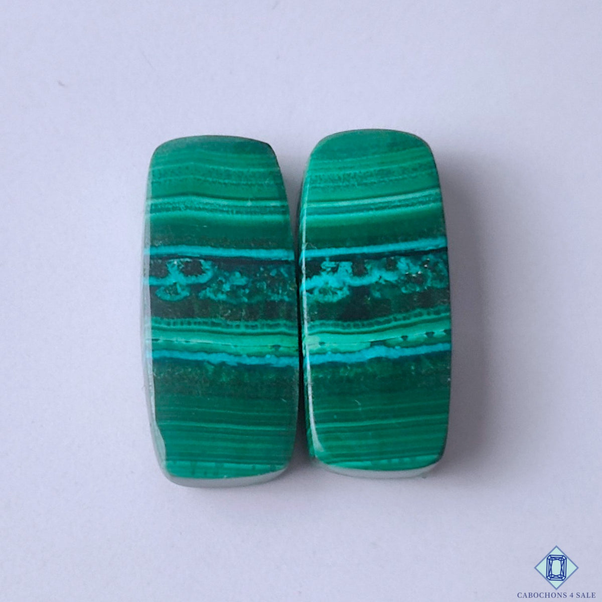 cabochons4sale, natural green malachite rectangular cabochons with bold layered bands, deep mineral tones and polished gemstone surfaces held between fingers