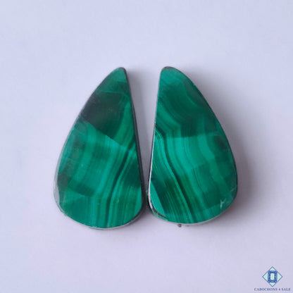 cabochons4sale, natural green malachite fancy cabochons with distinctive concentric banding, rich mineral patterns and polished gemstone surfaces held between fingers