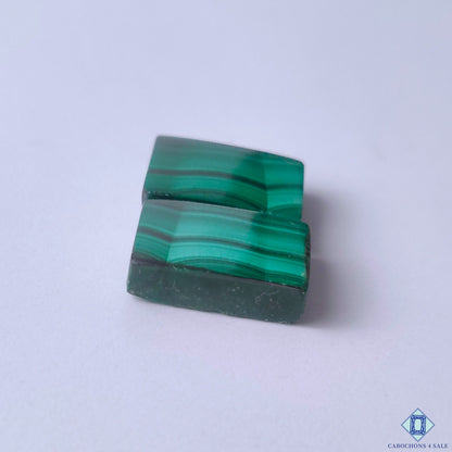 cabochons4sale, natural malachite rectangle cabochons showcasing swirling green patterns, layered stone texture and distinctive gemstone character held between fingers