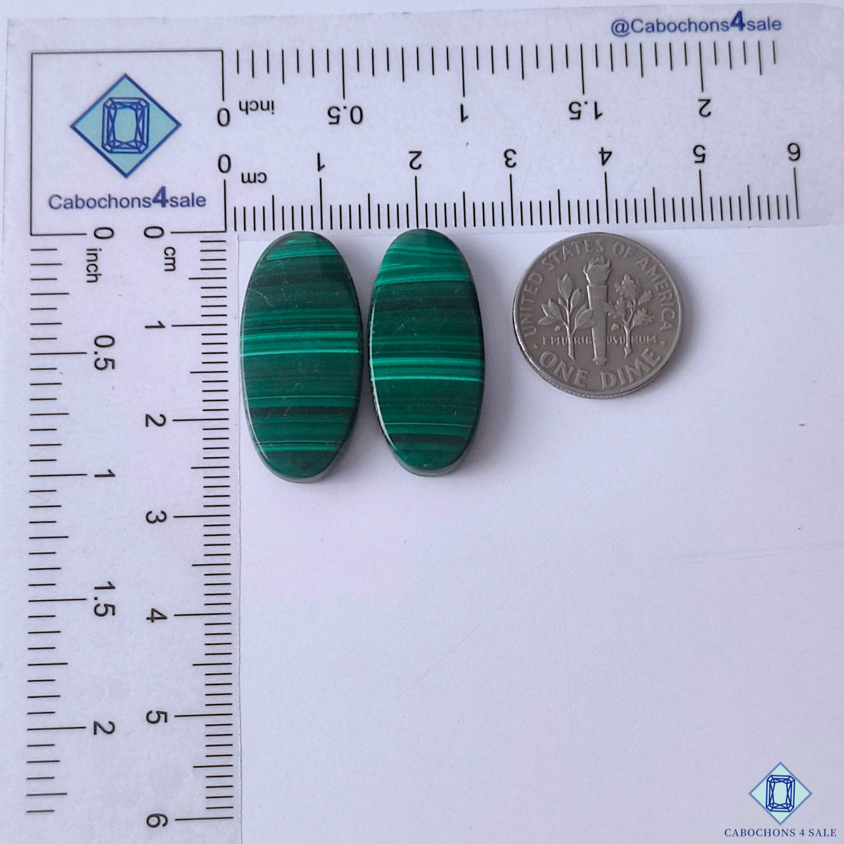 cabochons4sale, emerald green malachite oval gemstone cabochons featuring graceful concentric markings and a beautifully polished surface held between fingers