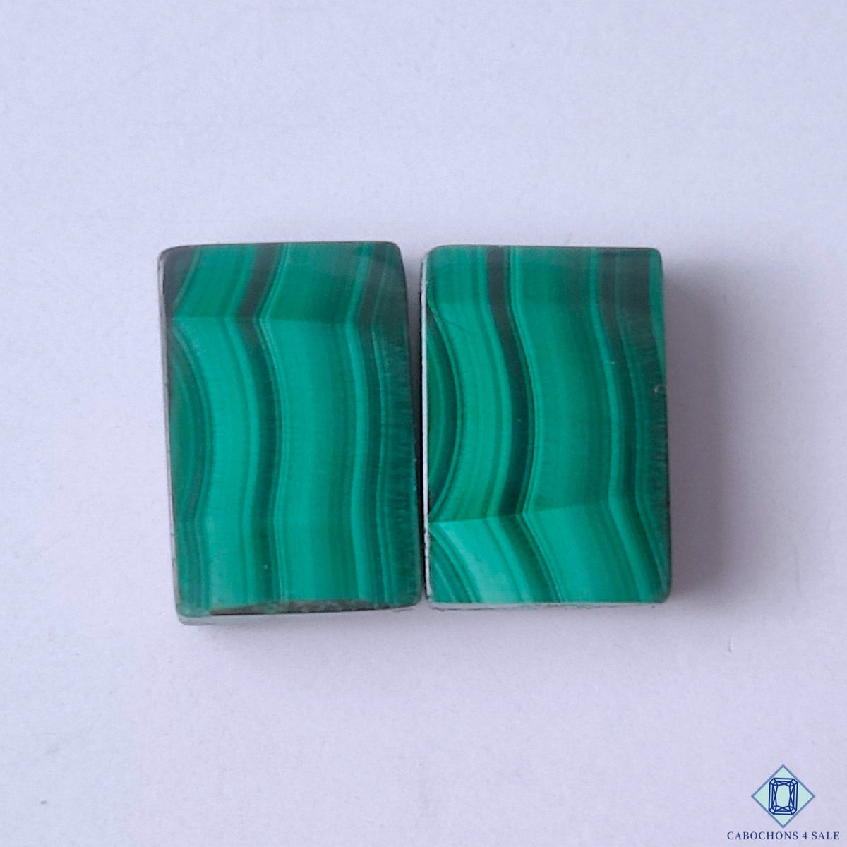 cabochons4sale, green malachite rectangle cabochons with bold natural banding, rich mineral layers and polished gemstone surfaces held between fingers
