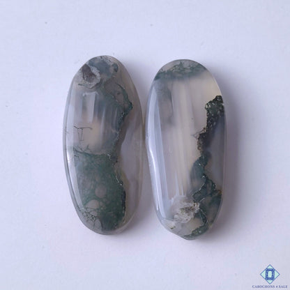 cabochons4sale, natural green moss agate oval cabochons with forest-like inclusions, organic mineral patterns and polished stone finish held between fingers