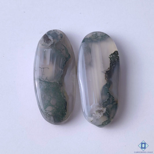 cabochons4sale, natural green moss agate oval cabochons with forest-like inclusions, organic mineral patterns and polished stone finish held between fingers