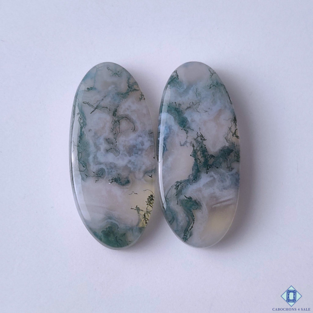 cabochons4sale, natural green moss agate oval cabochons with organic moss-like inclusions and earthy gemstone patterns held between fingers