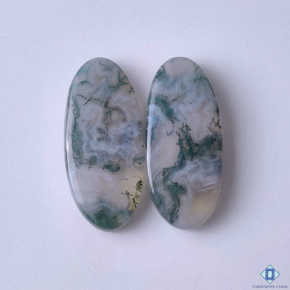 cabochons4sale, natural green moss agate oval cabochons with organic moss-like inclusions and earthy gemstone patterns held between fingers