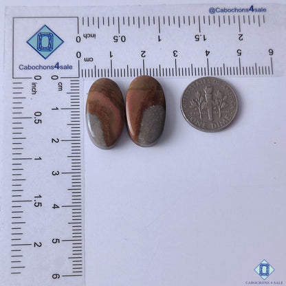 cabochons4sale, polished polychrome jasper oval gemstone cabochons featuring vibrant earth-tone layers, flowing patterns and unique natural stone character held between fingers