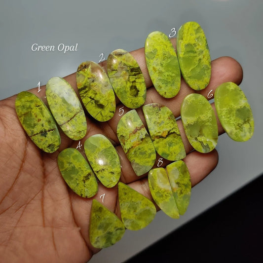 Cabochons4sale natural green opal gemstone pairs in various oval and teardrop shapes held in a hand