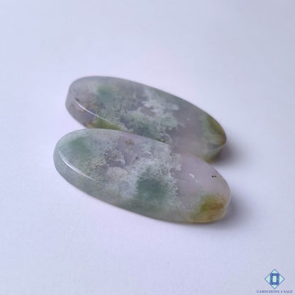 cabochons4sale, natural green moss agate oval cabochons featuring wispy botanical inclusions, smooth polish and distinctive gemstone character held between fingers