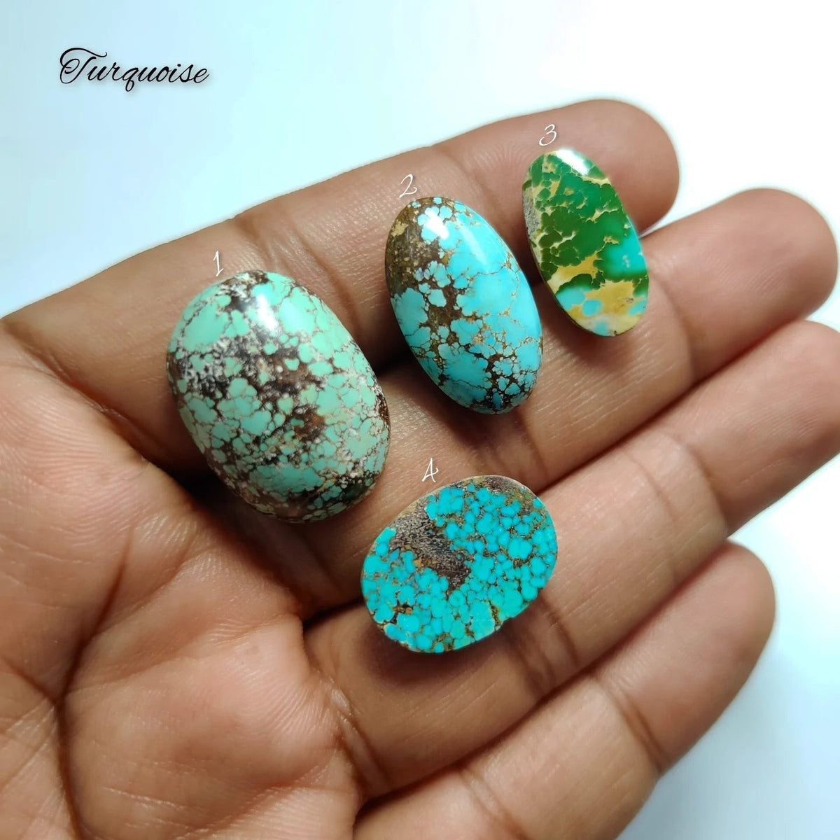 Cabochons4sale natural turquoise cabochons with unique blue-green matrix patterns held in a hand for jewelry making.