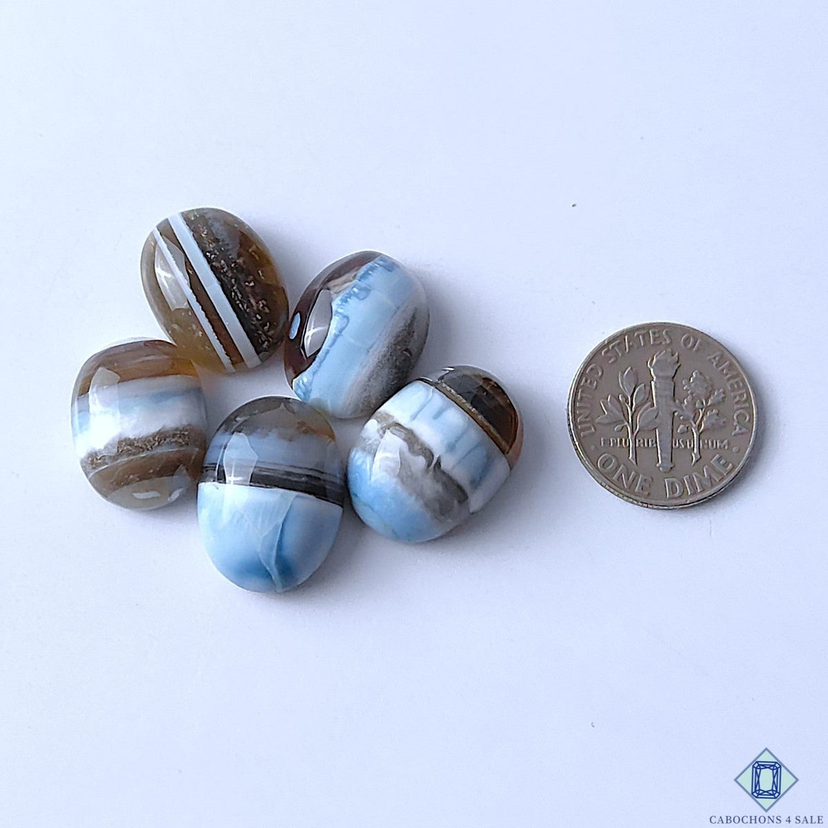 Cabochons4sale oval blue opal gemstones with banded patterns, shown next to a US dime for scale.