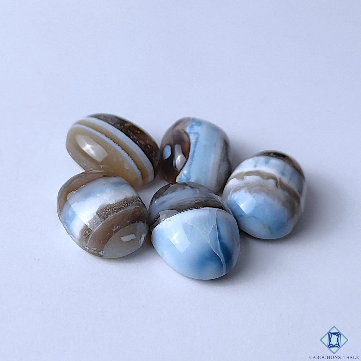 Cabochons4sale oval blue opal gemstones with opaque finish and natural brown and white banding patterns