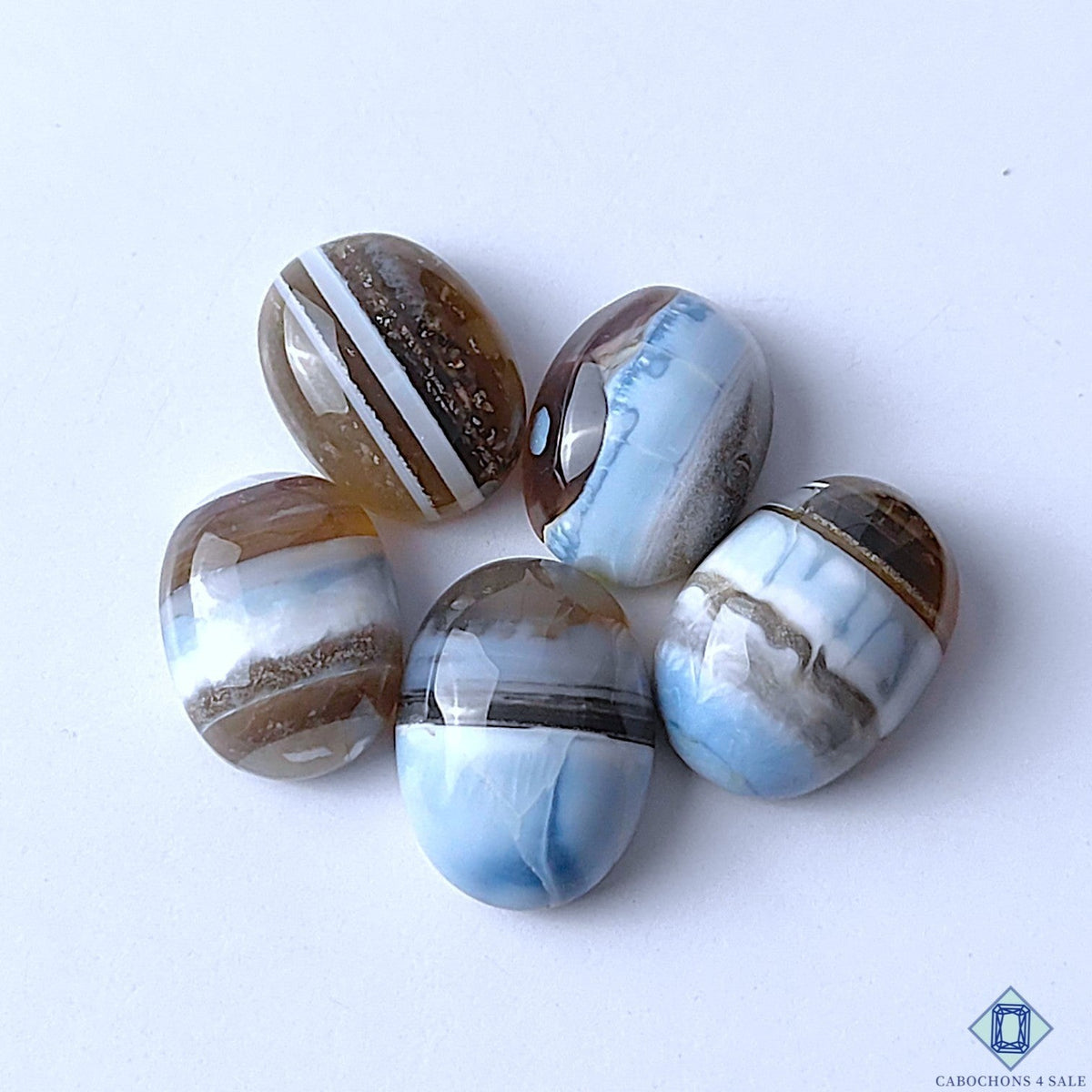 Cabochons4sale oval blue opal gemstones with natural brown and white striped patterns in a polished opaque finish