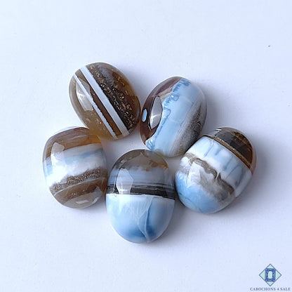 Cabochons4sale oval blue opal gemstones with natural brown and white striped patterns in a polished opaque finish
