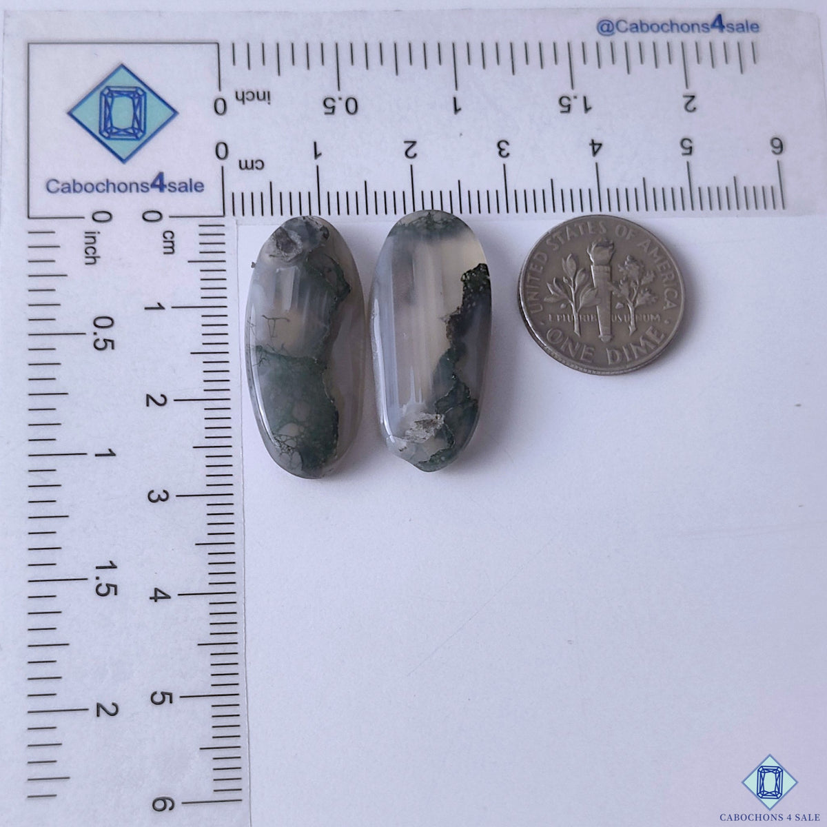 cabochons4sale, green moss agate oval gemstone cabochons displaying delicate branch-like formations, translucent areas and earthy natural beauty held between fingers