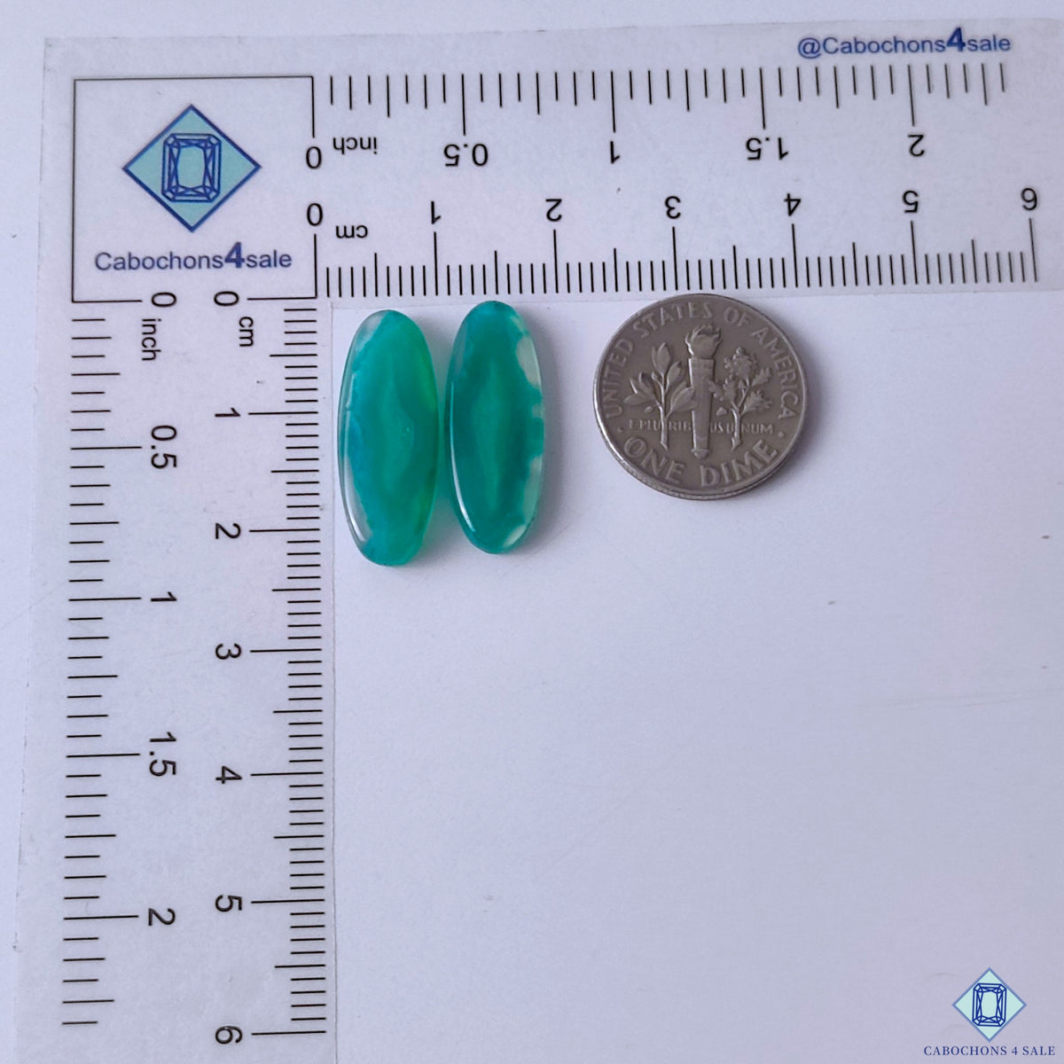 cabochons4sale, polished oval green banded agate cabochons showing contrasting white striping, flowing formations and unique gemstone character held between fingers