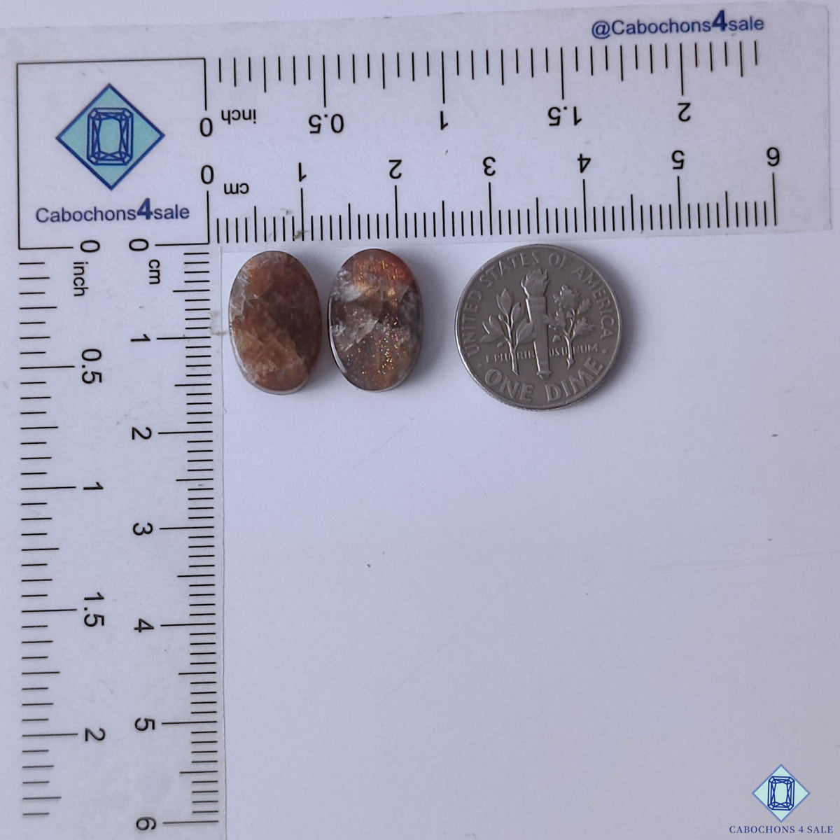 cabochons4sale, natural purple haze sunstone oval cabochons featuring soft violet color, delicate aventurescent sparkle and polished stone texture held between fingers