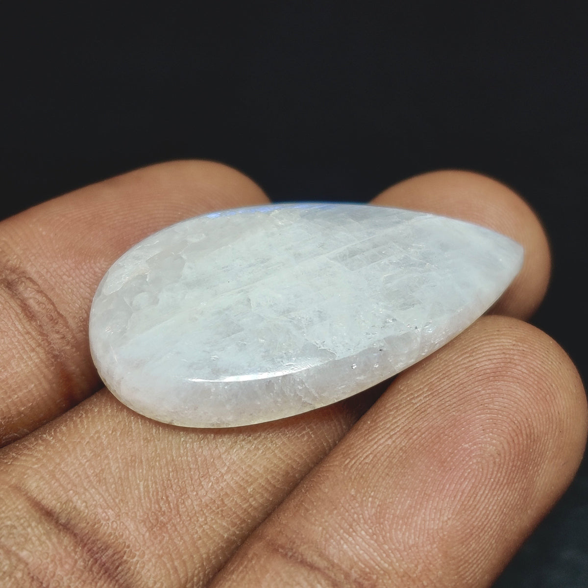 Cabochons4sale natural translucent white moonstone pear cabochon held in hand