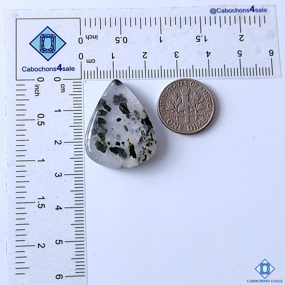 cabochons4sale, natural green tourmaline quartz pear cabochons with fine green tourmaline formations across a white quartz background, polished texture and unique gemstone character held between fingers