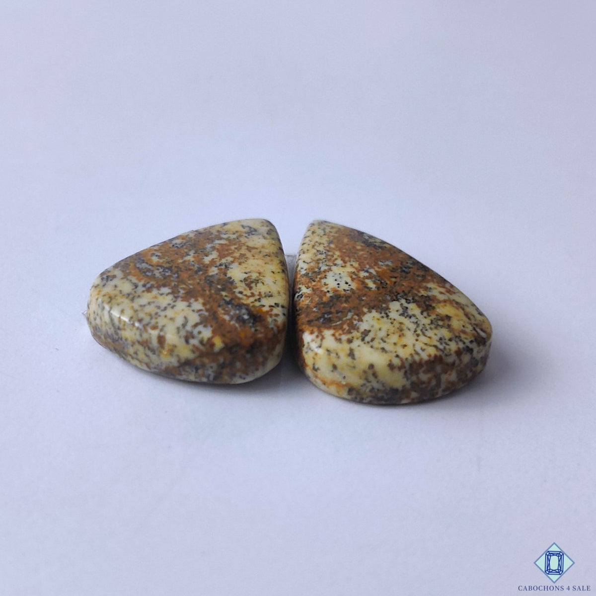cabochons4sale, polished brown picture jasper pear cabochons showcasing unique natural patterns, rustic tones and distinctive gemstone texture held between fingers