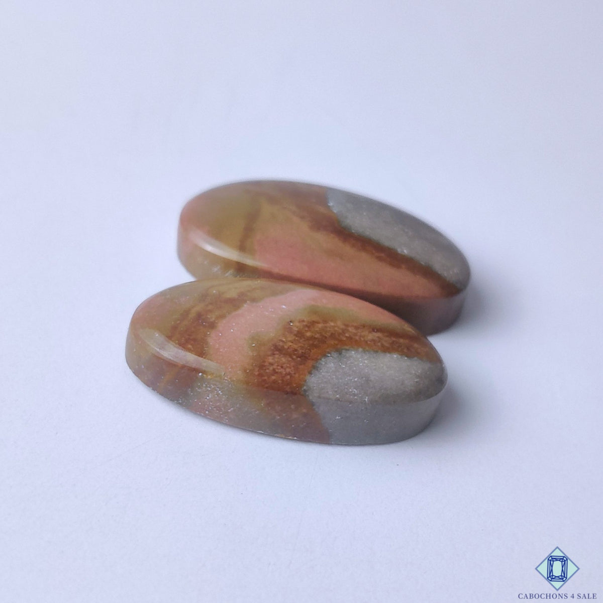 cabochons4sale, artistic multicolor polychrome jasper oval cabochons showcasing rich desert-inspired patterns, organic mineral textures and smooth polish held between fingers