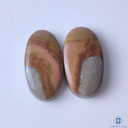 cabochons4sale, natural multicolor polychrome jasper oval cabochons with earthy red, cream and brown patterns held between fingers
