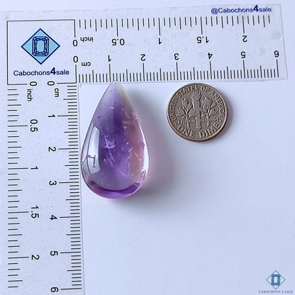 cabochons4sale, polished purple ametrine pear cabochons showcasing elegant violet coloration, natural internal zoning and distinctive quartz gemstone character held between fingers
